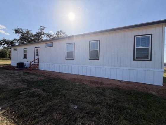 A long white home with white skirting running the full side wall.